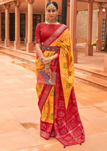 Load image into Gallery viewer, Saffron Yellow Printed Patola Silk Saree with Swaroski Work
